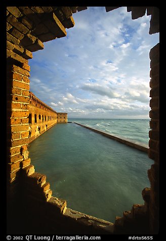 Fort Jefferson seawall and moat, framed by a crumpling embrasures, late afternoon. Dry Tortugas National Park (color)
