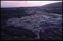 Live lava flow at sunset near the end of Chain of Craters road. Hawaii Volcanoes National Park, Hawaii, USA. (color)