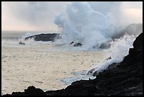 Steam rising off lava flowing into ocean. Hawaii Volcanoes National Park, Hawaii, USA. (color)