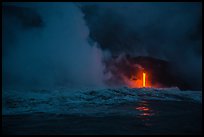 Lava runs down the cliff and goes into the sea at dawn. Hawaii Volcanoes National Park, Hawaii, USA. (color)