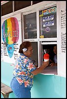 Woman with a flower in her hair getting shave ice, Waimanalo. Oahu island, Hawaii, USA (color)