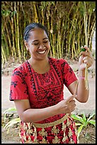 Tonga woman showing how to make cloth out of Mulberry bark. Polynesian Cultural Center, Oahu island, Hawaii, USA (color)