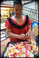 Woman preparing a fresh flower lei, International Marketplace. Waikiki, Honolulu, Oahu island, Hawaii, USA (color)