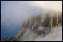 Fluted ridges seen through clouds, Kalalau lookout, late afternoon. Kauai island, Hawaii, USA