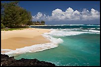 Beach and  turquoise waters, and homes  near Haena. North shore, Kauai island, Hawaii, USA