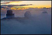 Telescopes, clouds, and fog at sunset. Mauna Kea, Big Island, Hawaii, USA