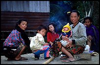 Group of women and children in a small hamlet. Mekong river, Laos