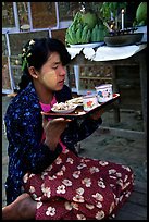 Burmese woman offering food. Bagan, Myanmar (color)