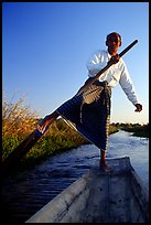 Intha man demonstrating leg-rowing. Inle Lake, Myanmar (color)