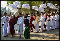 Umbrella bearer, Monks, and donation holders in alms procession. Mandalay, Myanmar ( color)