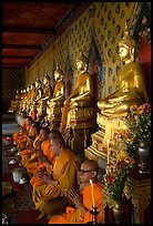 Buddhist monks and buddha statues, Wat Arun. Bangkok, Thailand (color)