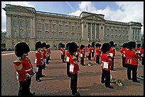 Rows of guards  wearing bearskin hats and red uniforms. London, England, United Kingdom (color)