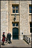Yeoman Warder talking with man in suit in front of the Jewel House, Tower of London. London, England, United Kingdom ( color)
