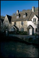 Cotswold type cottages and Bybrook River, Castle Combe. Wiltshire, England, United Kingdom ( color)