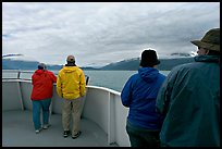 Passengers standing on deck with colorful  clothes. Seward, Alaska, USA