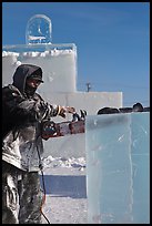 Sculptor using electric saw to carve ice. Fairbanks, Alaska, USA (color)