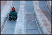 Girl on slide made of ice, George Horner Ice Park. Fairbanks, Alaska, USA (color)