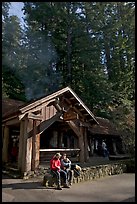 Couple sitting in front of park headquarters, afternoon. Big Basin Redwoods State Park,  California, USA (color)