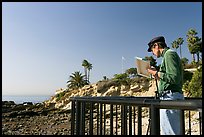 Painter working from an overlook. Laguna Beach, Orange County, California, USA (color)