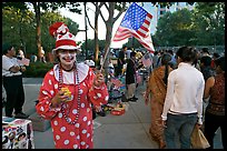 Woman in clown costume waiving American Flag, Independence Day. San Jose, California, USA (color)