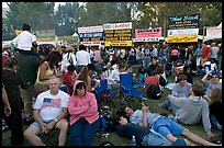 Crowd sitting on the grass in Guadalupe River Park, Independence Day. San Jose, California, USA (color)