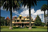 Palm trees and mansion facade. Winchester Mystery House, San Jose, California, USA ( color)
