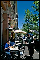 Streetside restaurant terrace and waiter. Santana Row, San Jose, California, USA
