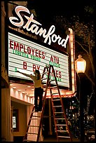 Woman changing movie title, Stanford Theatre. Palo Alto,  California, USA