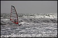 Windsurfer on silvery ocean, Waddell Creek Beach. California, USA
