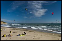 Kitesurfers rolling out sails on on beach, Waddell Creek Beach. California, USA (color)