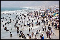 Crowds of beachgoers in water. Santa Monica, Los Angeles, California, USA (color)