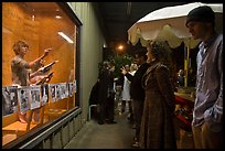 People watch performance artists in window, Bergamot Station. Santa Monica, Los Angeles, California, USA (color)