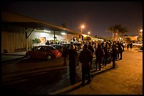 People lining up to enter a gallery at night, Bergamot Station. Santa Monica, Los Angeles, California, USA