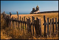 Fences, summer grass and chapel towers, Fort Ross. Sonoma Coast, California, USA (color)