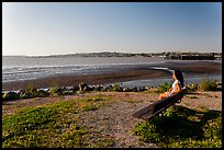 Woman sitting on bench, Carquinez Strait Regional Shoreline. Martinez, California, USA ( color)