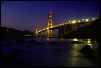 Golden Gate bridge and surf seen from E Baker Beach, night. San Francisco, California, USA