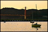 Sailboat in the Marina, with Golden Gate Bridge at sunset in the background. San Francisco, California, USA ( color)