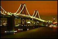 Bay Bridge seen from Treasure Island with defocused lights, sunset. San Francisco, California, USA