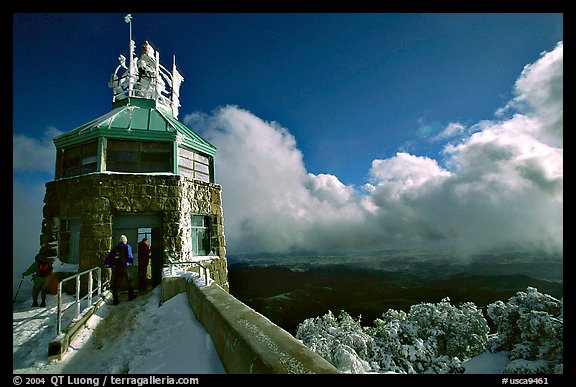 Hikers take refuge in the ice-clad summit tower during a cold winter day, Mt Diablo State Park. California, USA