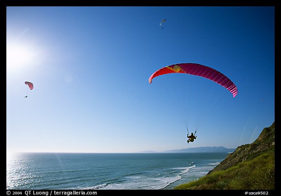 Paragliders soaring above the Ocean, the Dumps, Pacifica. San Mateo County, California, USA (color)