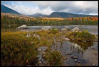 Mountains with fall colors rising above pond. Baxter State Park, Maine, USA