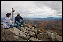 Hikers taking in view near sign marking summit of South Turner Mountain. Baxter State Park, Maine, USA (color)