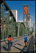 Jogger and cyclist on Hawthorne Bridge. Portland, Oregon, USA