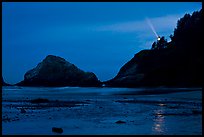 Heceta Head and lighthouse beam from beach by night. Oregon, USA (color)