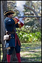 Man in period costume fires smooth bore musket, Fort Matanzas National Monument. St Augustine, Florida, USA (color)