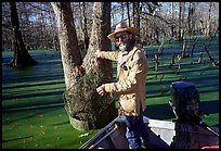 Bayou guide of French descent retriving net,  Lake Martin. Louisiana, USA ( color)