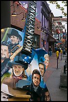 Guitar-shaped sign with images of famous singers on Broadway sidewalk. Nashville, Tennessee, USA (color)