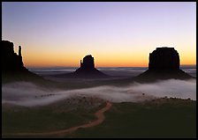 Mittens and fog, sunrise. Monument Valley Tribal Park, Navajo Nation, Arizona and Utah, USA