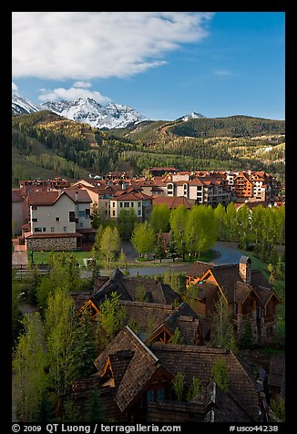 Mountain Village with newly leafed spring trees and snowy peaks. Telluride, Colorado, USA