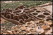 Tourists inspecting the complex room arrangement of Pueblo Bonito. Chaco Culture National Historic Park, New Mexico, USA (color)
